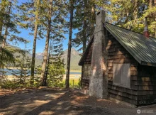 his unique off-grid cabin offers rustic living space with a loft and porch featuring views of Keechelus Lake.$99,900