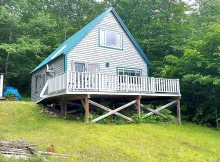 Motivated seller! Nestled on 5 +/- acres, this one of a kind 2 bedroom chalet offers amazing mountain views from its unique catwalk dining area. $185,000